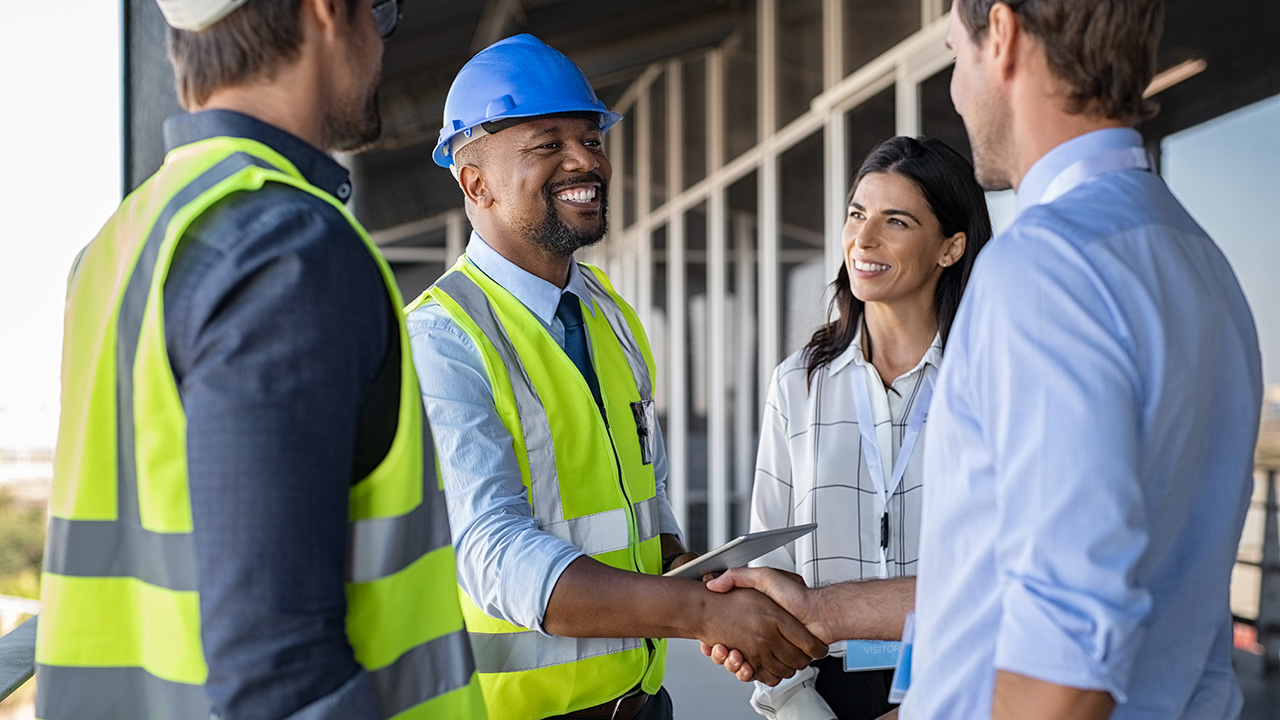 four people having a conversation two are shaking hands